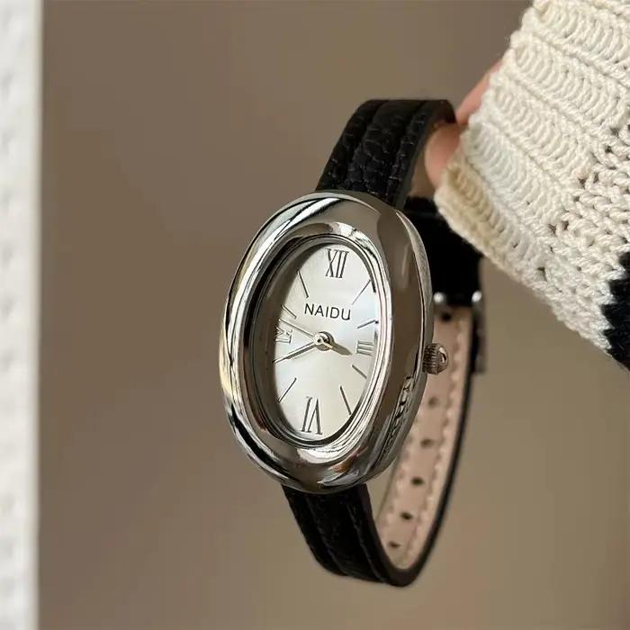 Montre ovale luxueuse style rétro haute qualité pour femmes occasions spéciales quartz bracelet large polyvalent